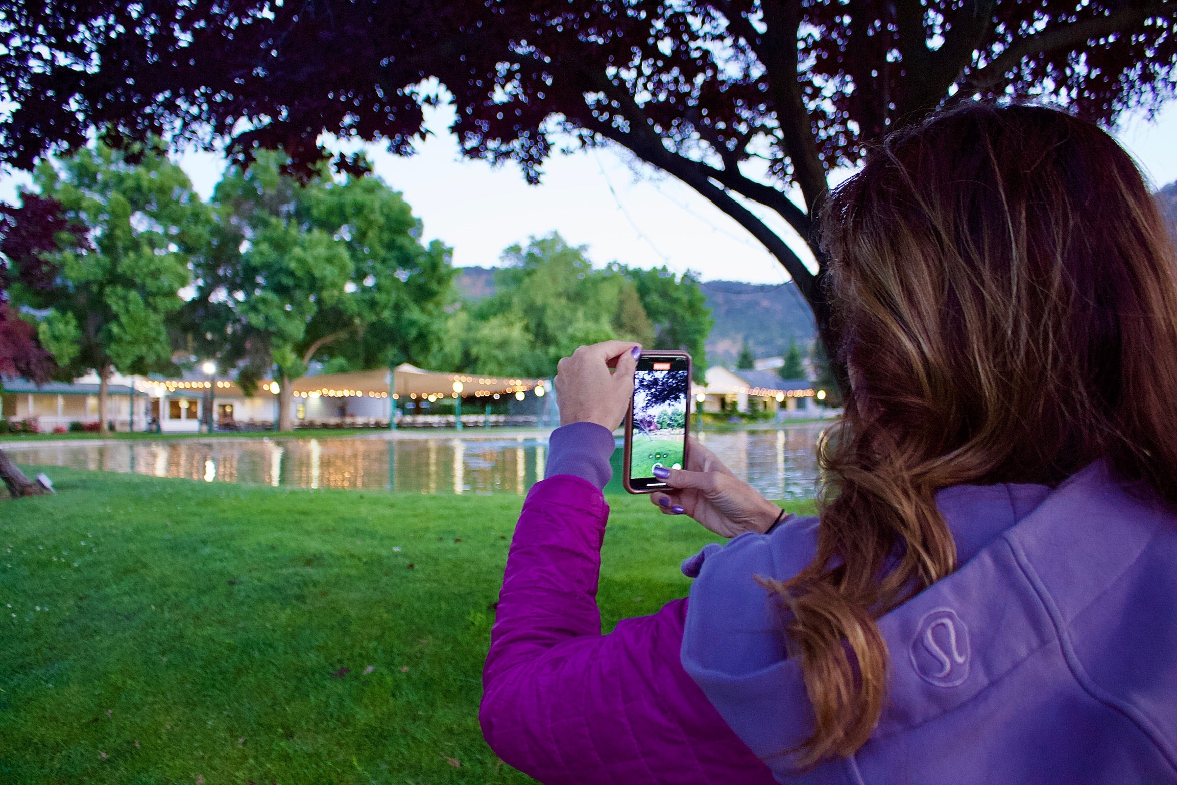 picture of a woman taking a picture of a lake at wonder valley resort