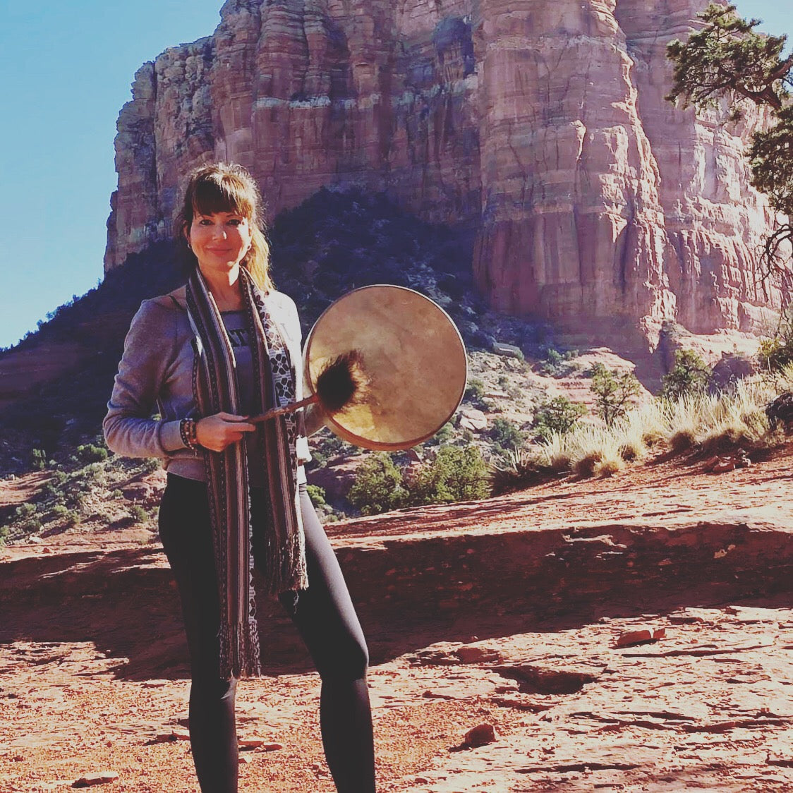 dana haines with a drum in front of sedona red rocks