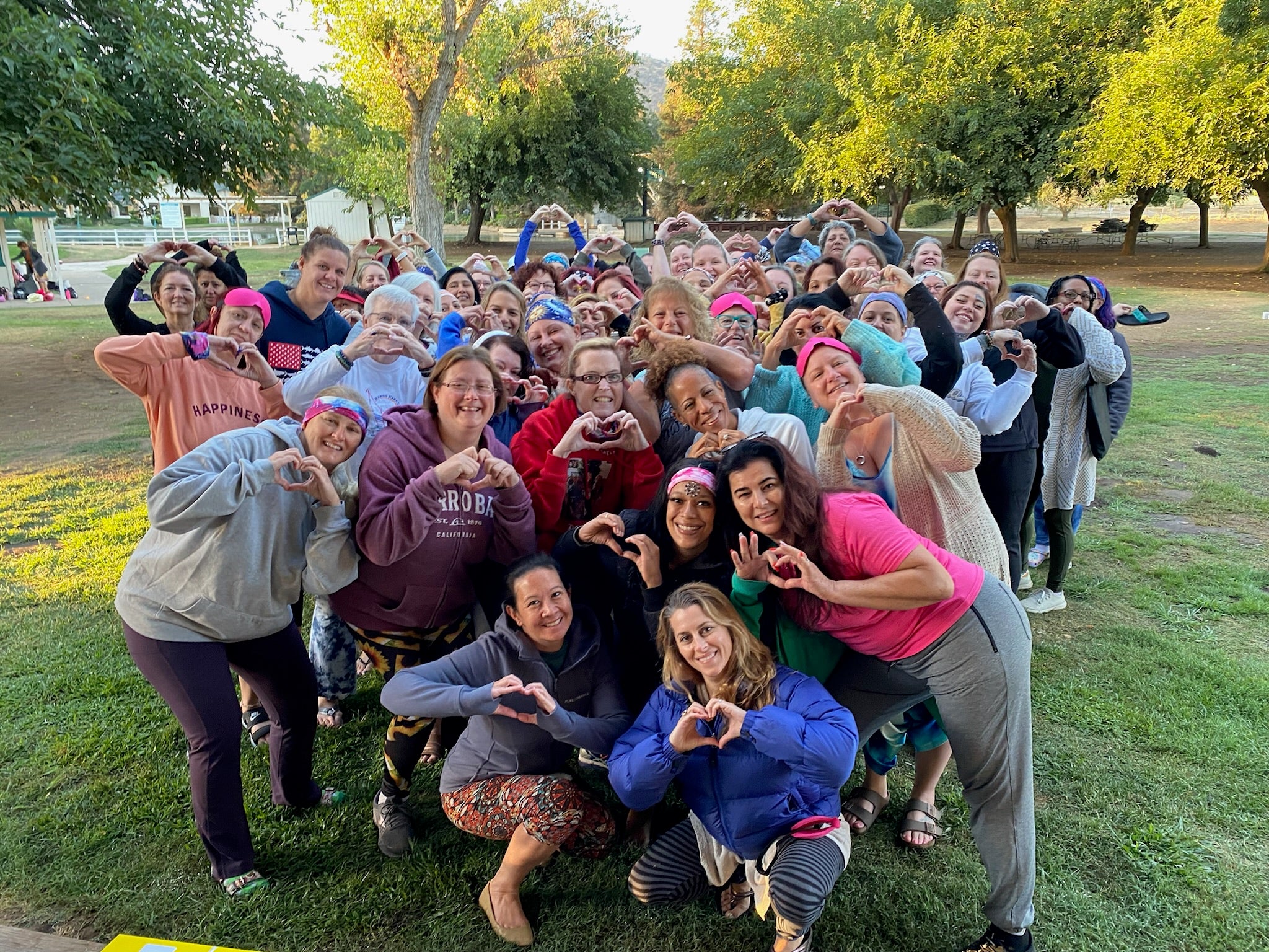 group of women putting up heart signs